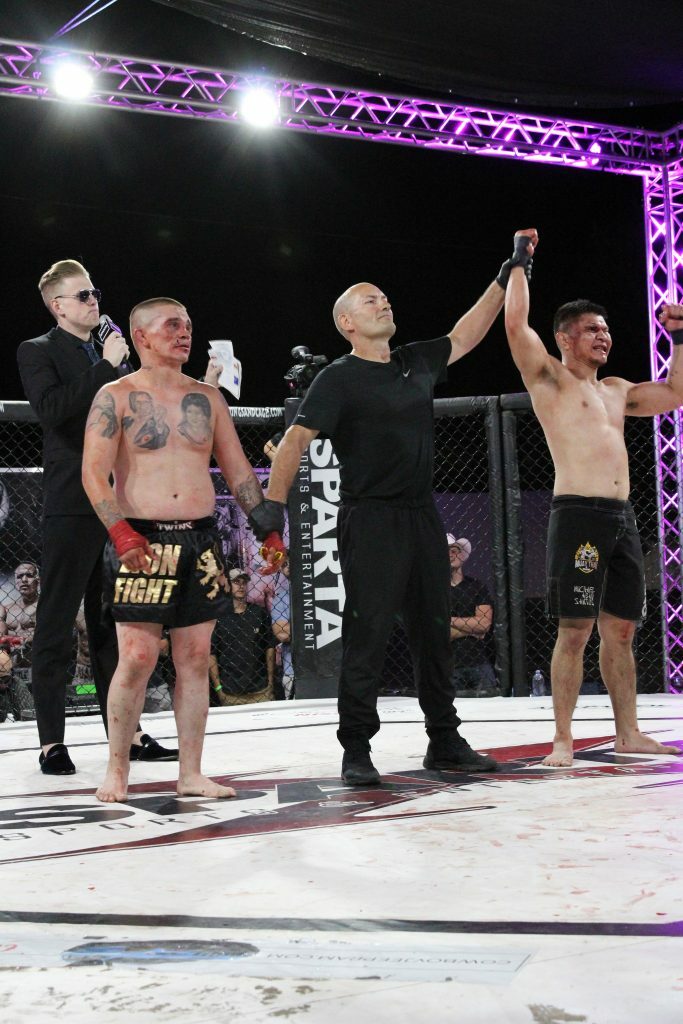 Michael Santos getting his hand raised at Sparta BKMMA. Photo credit Ashlee Moreno.