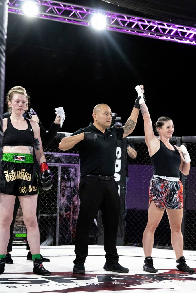 Khortni Kamyron getting her hand raised. Photo credit Ashlee Moreno.