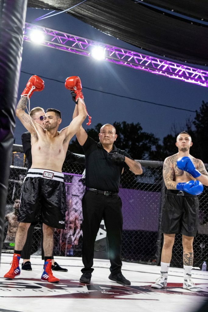 Fernando Acosta getting his hand raised. Photo credit Ashlee Moreno.