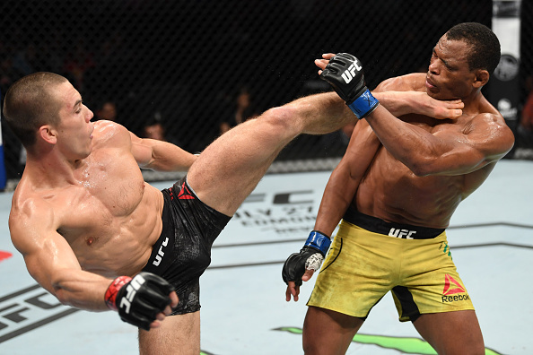 Alexander Hernandez kicking Francisco Trinaldo