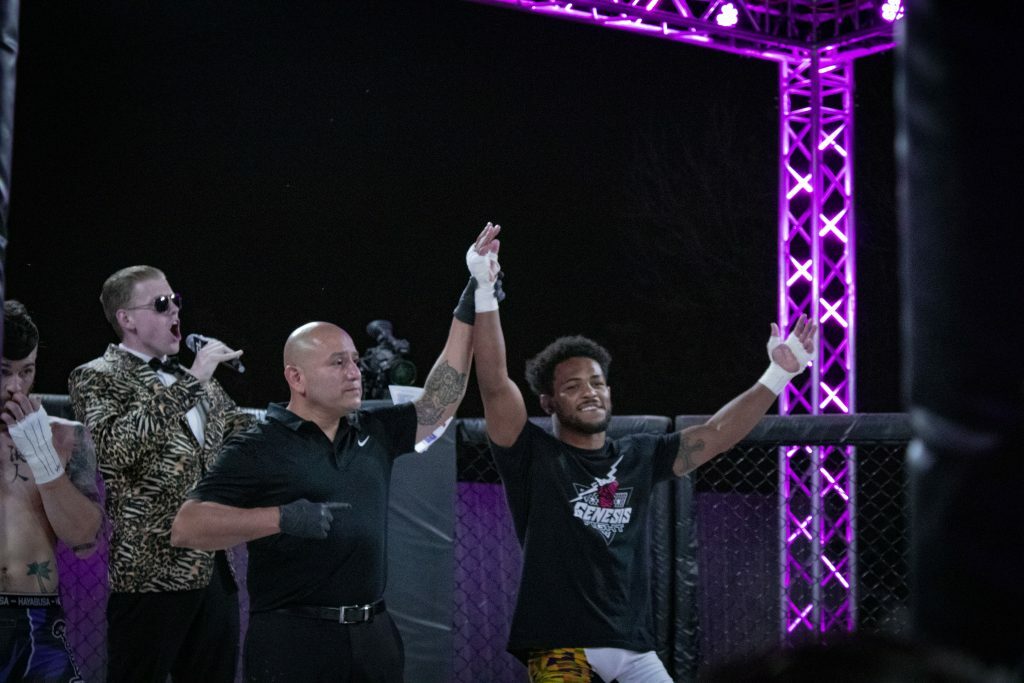 Sparta Welterweight Champion winner Archie Colgan getting his hand raised after winning. Photo credit Ashlee Moreno.
