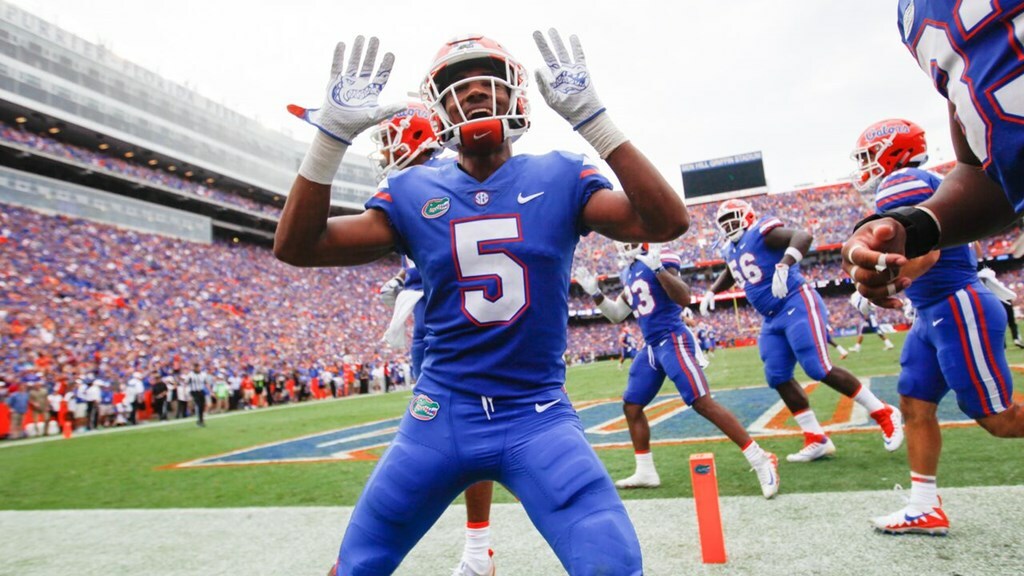 NFL Mock Draft selection C.J Henderson poses in the end zone with his fellow teammates