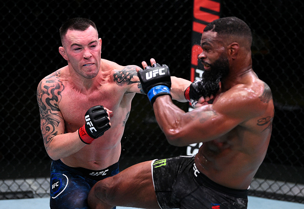 Colby Covington punching Tyron Woodley. 