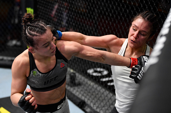 Alexa Grasso landing a punch on Maycee Barber. UFC 258 medical suspensions