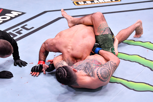 Hernandez sinking in the guillotine choke on Vieira. UFC 258 Medical suspensions