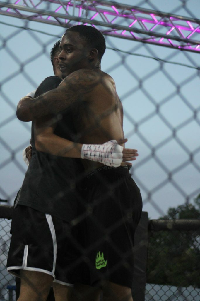 Sparta Wyoming match 3 winner Mikkel Knight Jr hugging opponent Johnet Yong after the fight. Photo credit Ashlee Moreno.
