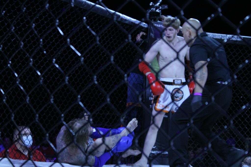 Match 10 winner Dylan Penland standing over Mitch Seybold as he holds his ankle. Photo credit Ashlee Moreno.