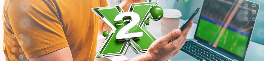 Image shows a man holding a smartphone in front of a laptop. Featured is an "X2"