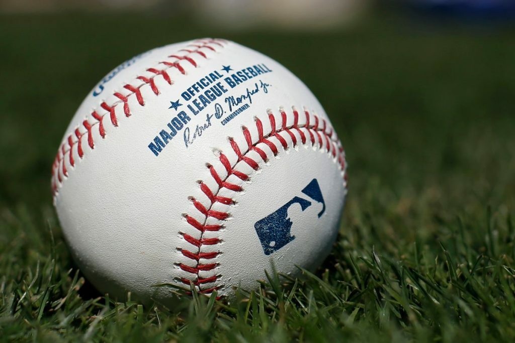 MLB baseball in grass. 