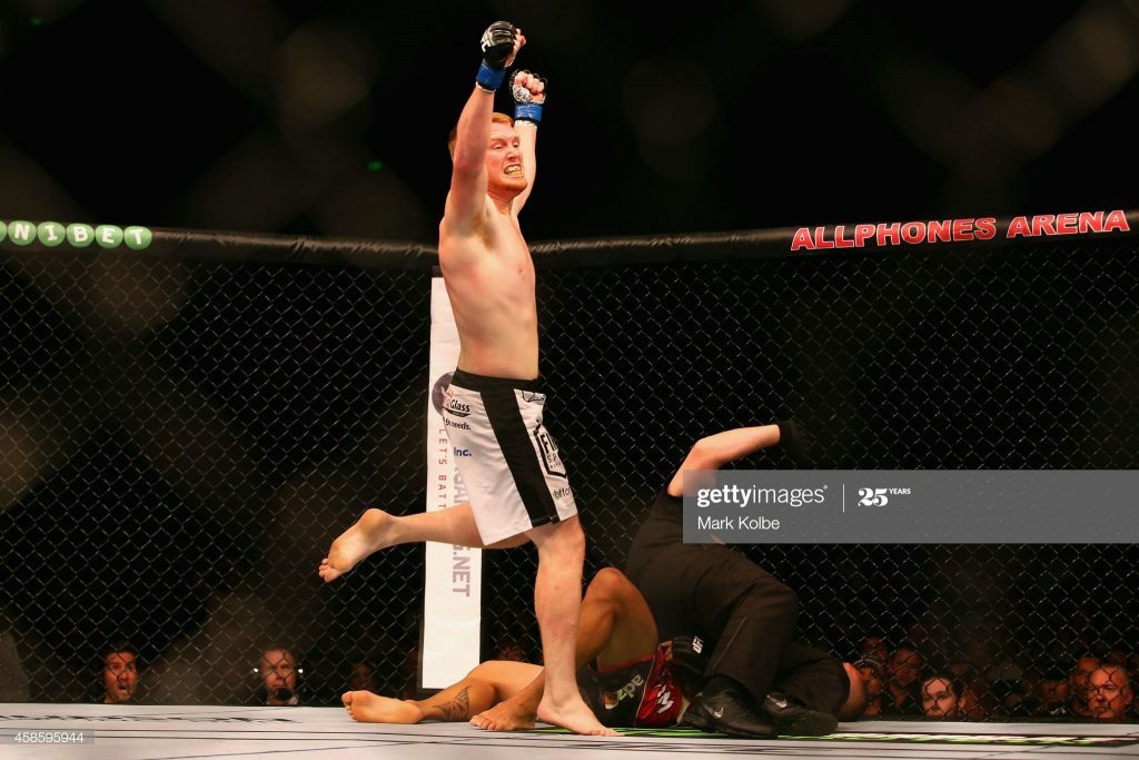 Sam Alvey celebrating with arms up