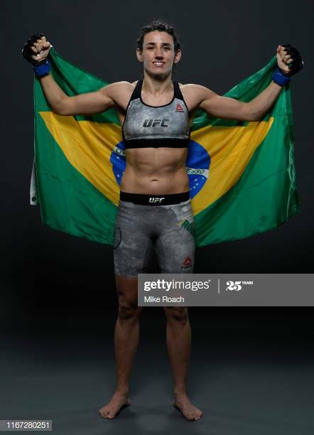 Marina Rodriguez holding up a Brazilian flag. Esparza vs Rodriguez.