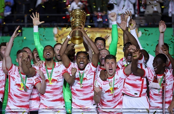 Cup winners RB Leipzig celebrating their trophy, while Bayern Munich take home the German Bundesliga.