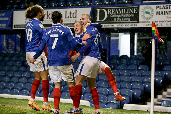 Portsmouth players pictured celebrating after going ahead against league high fliers Peterborough in League one.