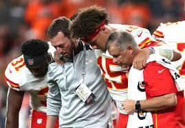 Patrick Mahomes is helped off the field after suffering a dislocated kneecap