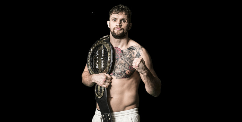 John Phillips holding a championship belt