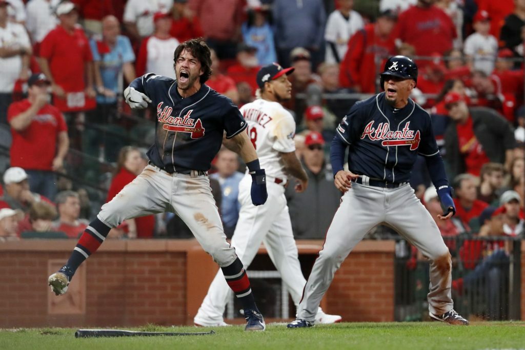 Dansby Swanson #7 of the Atlanta Braves looks on from third base during a  pitching change in the sixth inning during MLB g…