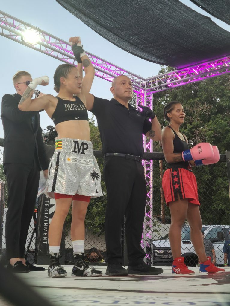 Maliah Paculan getting her hand raised. Photo credit Jeff Swartz.